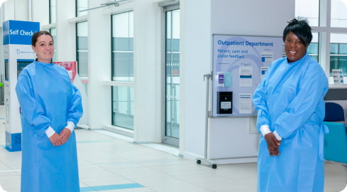 Katerina Pegg and Senior Infection Control Specialist Nurse Sophie Byfield wearing the surgical gowns